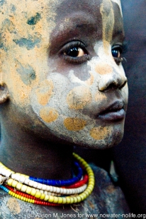 Ethiopia: Lower Omo River Basin, Lebuk, a Karo village, during dancing ceremony, portrait of Karo child covered in face paint